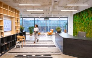 A woman walks in the Denver office